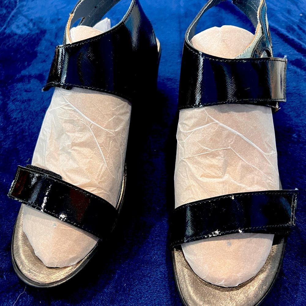 These are a BRAND NEW pair of NAOT patent wedges. They have never been worn.